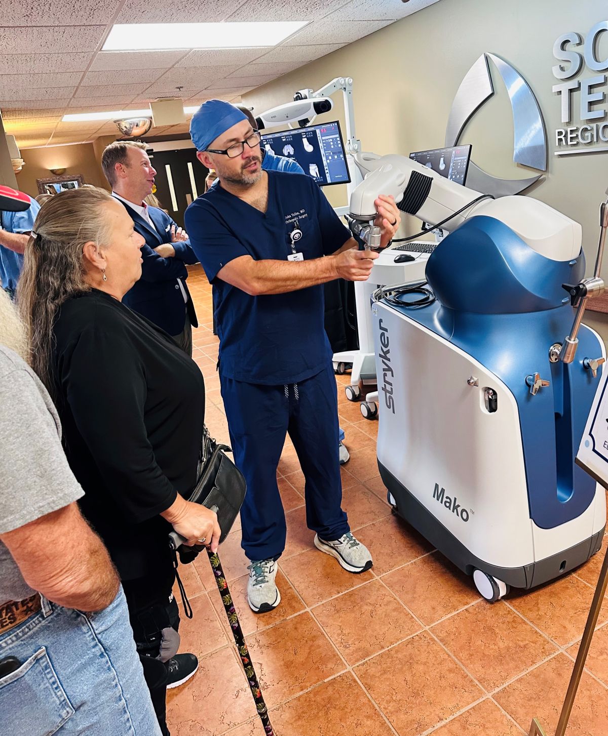 Dr. Tullos demonstrating robot capabilities to community member.